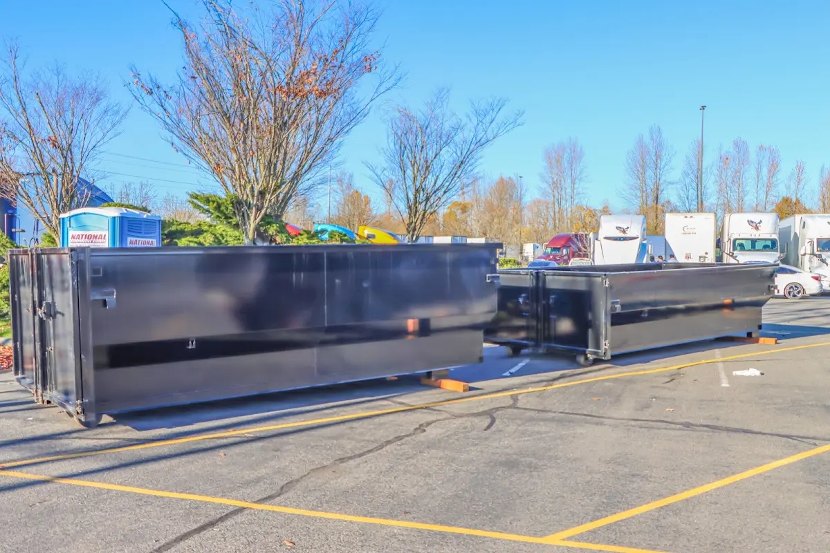 Professional dumpster rental service with roll-off container on residential driveway in Delmar